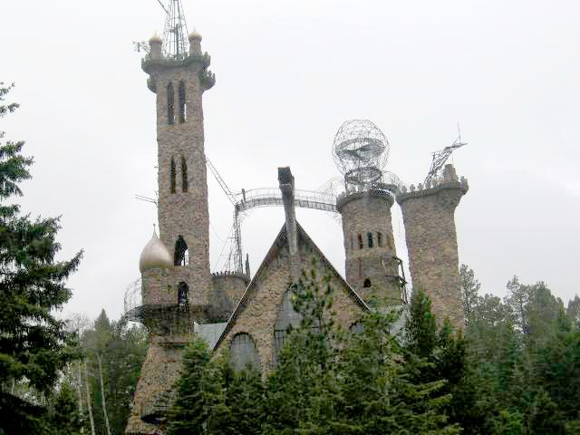 Elaborate stone castle with iron spires built into mountainside