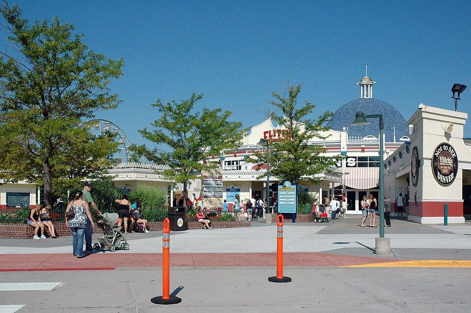 Amusement park roller coaster against blue sky