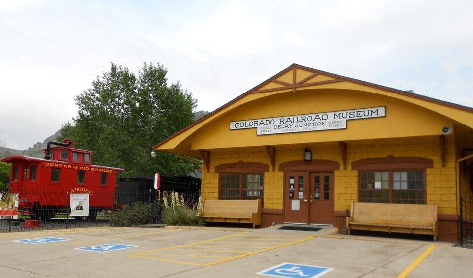 Vintage narrow-gauge steam locomotive on display outdoors