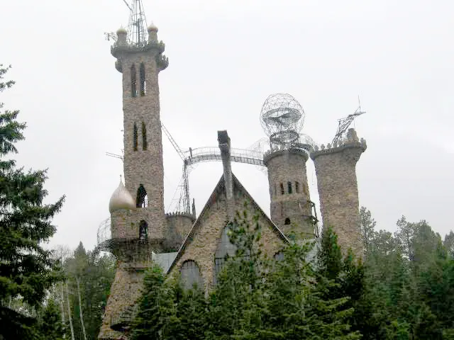 Elaborate stone castle with iron spires built into mountainside
