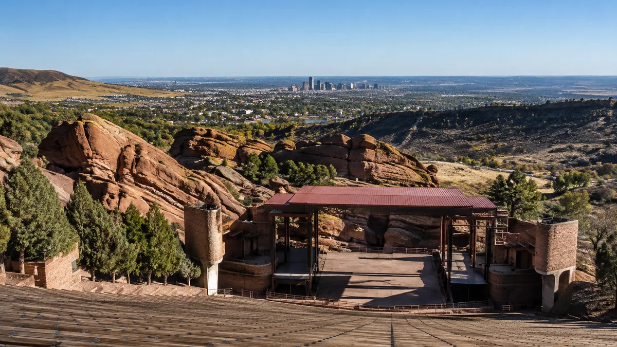 the Denver skyline seen from the top row of Red Rocks Amphitheatre at night