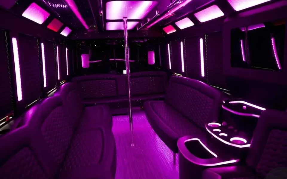 LED-lit party bus interior with wrap-around bench seating