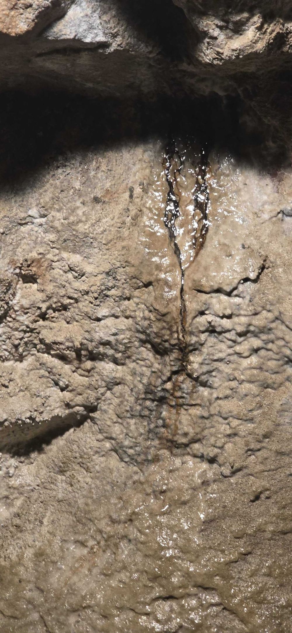 Dragon's blood — dark silver oxide seepage trickling down the rock wall inside the Lebanon Mine
