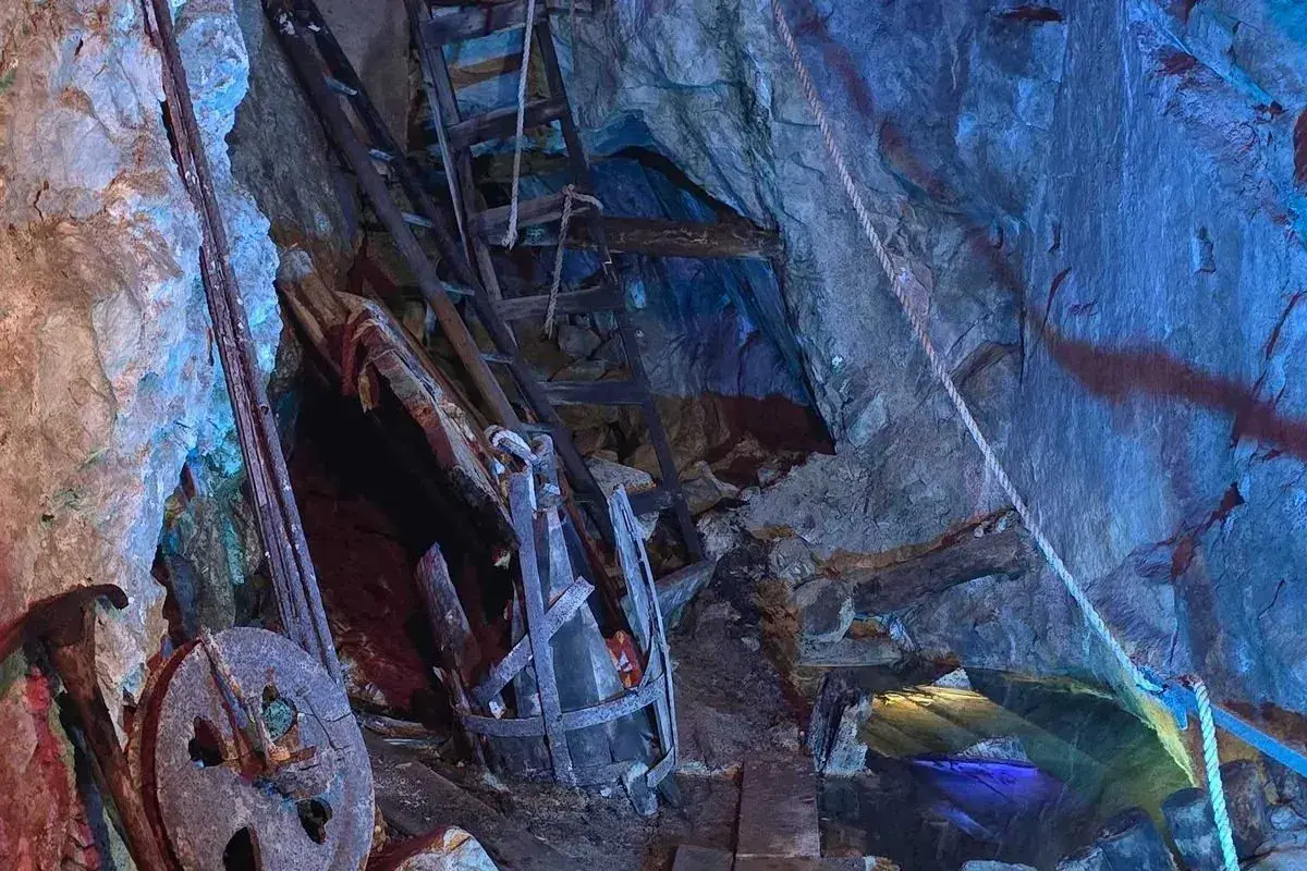 Inside the Lebanon Silver Mine — ore carts, ladders, and colored lights illuminate a stope carved in the 1870s
