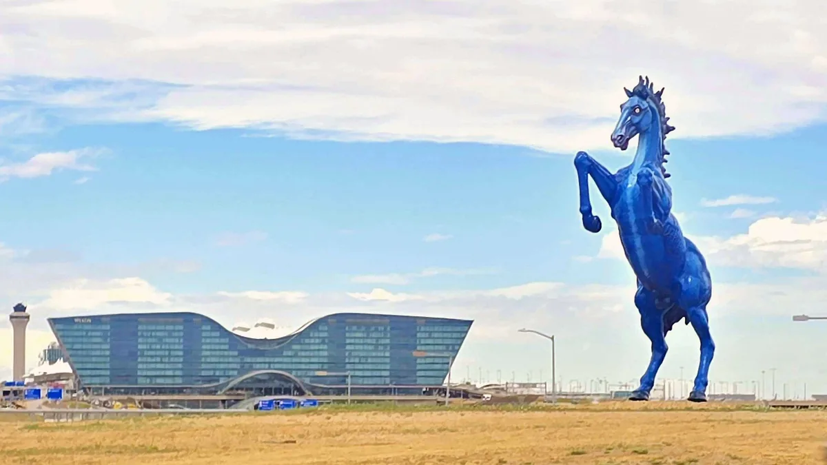 Mustang, the blue horse sculpture, rearing beside Pena Boulevard at the Denver International Airport entrance